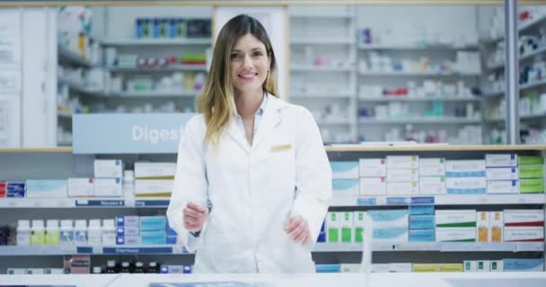 Pharmacy, store and retail health industry woman pharmacist ready to work and help a customer. Happy healthcare and customer service worker portrait and medicine, pills and pharmaceutical shop stock. - Video