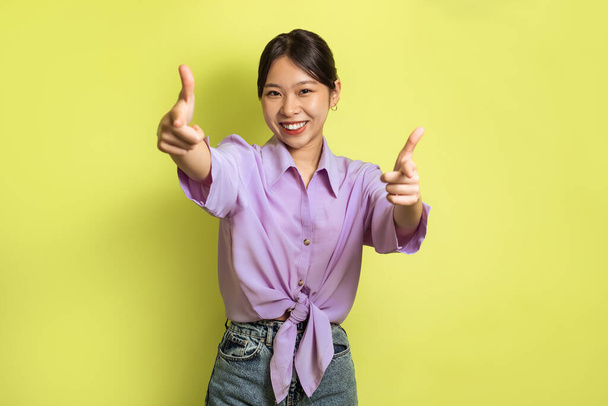You Are Next. Happy Asian Lady Pointing Fingers To Camera Standing Posing Over Yellow Studio Background. I Choose You, Advertisement Banner. Selective Focus - Foto, imagen