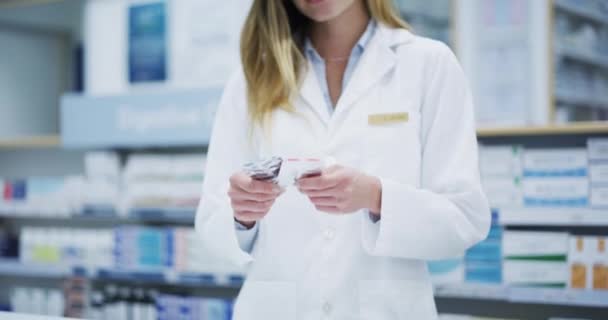 Pharmacist, medicine or trust with pharmacy healthcare product or insurance pills. Portrait of smile, happy and support woman, employee or wellness worker in retail store for medical help. - Felvétel, videó
