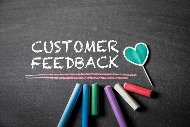 Customer Feedback. Colored pieces of chalk and text on the blackboard. - Foto, afbeelding