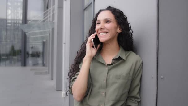 Female woman happy cheerful success amazed wonder businesswoman lady talking conversation remote distant talk answer call listening good news win say wow amazing speaking with smartphone outdoors - Footage, Video