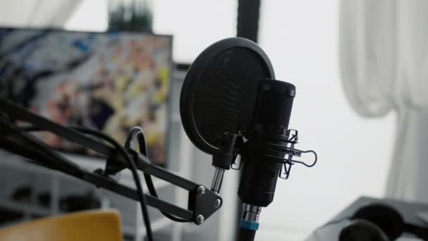 Microfone profissional em stand instalado em estúdio em casa. Dispositivo de podcast condensador de gravação de alta tecnologia na sala de estar vazia equipada com equipamento de streaming eletrônico. Fechar - Filmagem, Vídeo