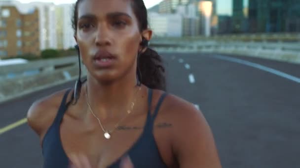 Running, music and fitness with a woman athlete training on a run for health, wellness and exercise. Sport, healthy and motivation with a young female runner exercising and working out in the city. - Filmmaterial, Video