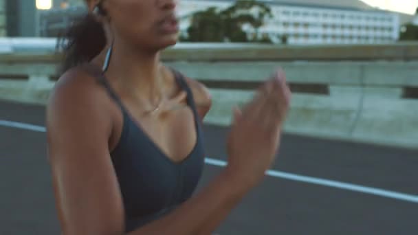 Motivation, music and running with fitness woman training run for health, wellness and exercise in urban street or road. Sport, workout and energy girl runner working out for event, race or marathon. - Metraje, vídeo