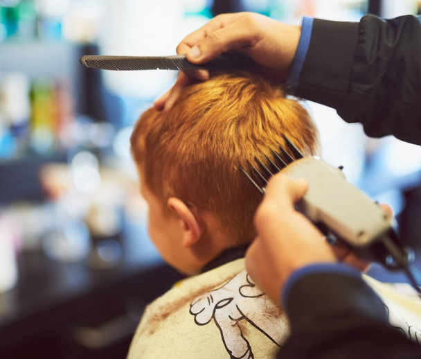 Keeping it short and stylish. Closeup shot of a young boy getting a haircut at a barber shop - Φωτογραφία, εικόνα