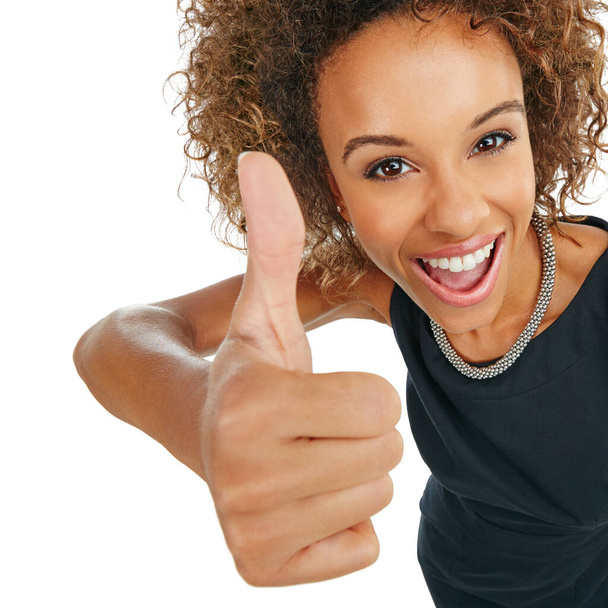 Go for it. Studio portrait of an attractive young businesswoman showing thumbs up against a white background - Foto, afbeelding
