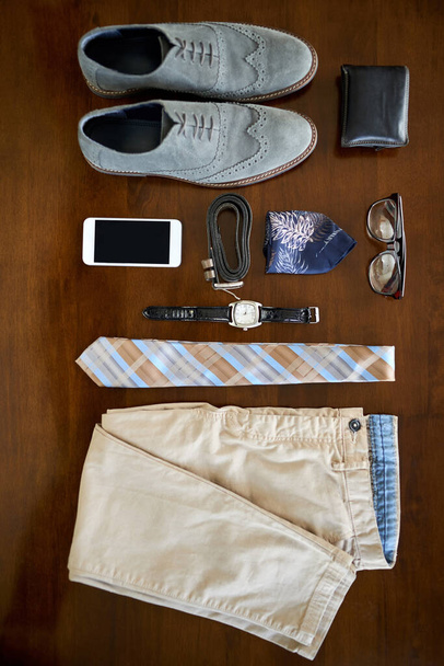 The modern executives essentials. High angle shot of a stylish business outfit and accessories laid out on a table - Foto, afbeelding