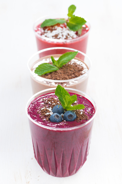 Blueberry, chocolate and strawberry milkshakes in glasses - Photo, image