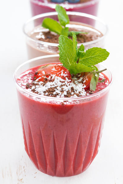 Strawberry, blueberry and chocolate milkshakes in glasses - Фото, зображення