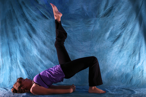Woman in One Legged Bridge yoga pose - Photo, Image