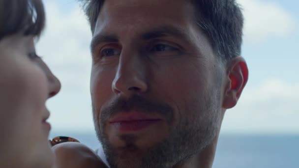 Romantic couple look each other with love ocean view closeup. Portrait of romantic couple flirting at panoramic window luxury hotel. Sensual lovers spending summer vacation together. Honeymoon concept - Filmagem, Vídeo