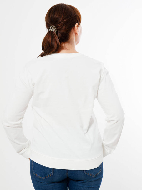 woman in white pullover posing on white background - back view - Foto, afbeelding