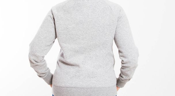back view : beautiful european mid aged woman dressed in a light grey casual hooded jacket - studio shot in front of a white background - Zdjęcie, obraz