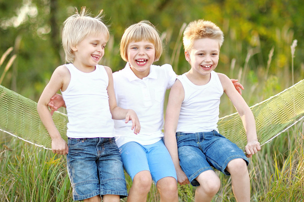 three children playing on meadow in summer - Foto, Bild