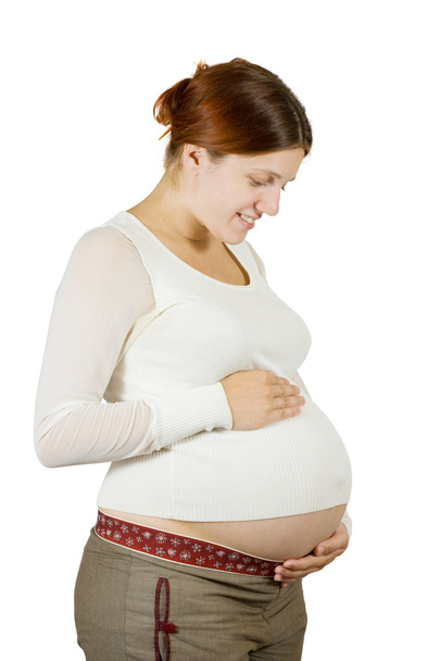 Happy pregnant woman holding her tummy - Фото, зображення