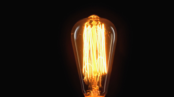 incandescent light bulb switched on isolated on black with copy space - Φωτογραφία, εικόνα