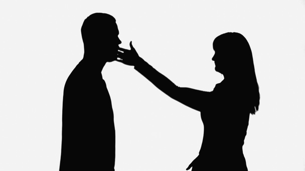 shadow of wife giving slap to husband while quarreling isolated on white - Photo, Image
