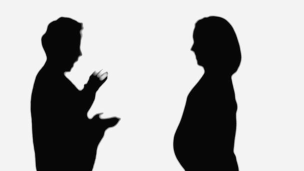 silhouette of pregnant woman near surprised friend showing wow gesture isolated on white - Fotoğraf, Görsel