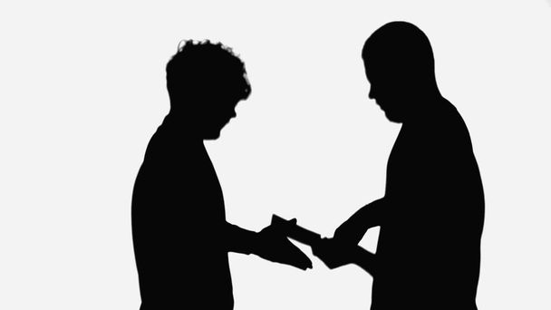 silhouette of man taking money from employer isolated on white - Φωτογραφία, εικόνα