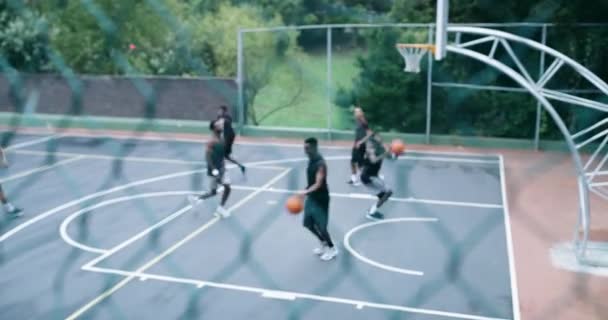 Sports, basketball and team playing a game on an outdoor court training or preparing for a match. Fitness, skill and healthy group of men running and doing a dunk exercise on a professional field - Séquence, vidéo