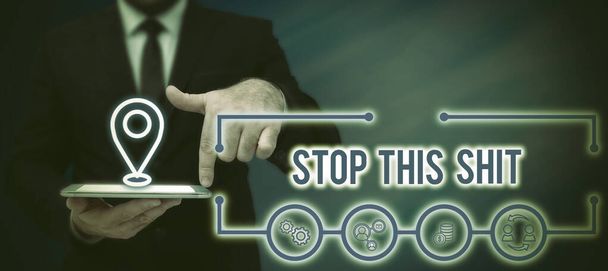 Text sign showing Stop This Shit, Concept meaning Enough of bad things happening To be upset for something Businessman With A Pad Pointing On Globe Showing Digital Connectivity. - Photo, Image