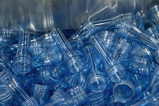 The close up scene of group of preform shape of PET bottle products. The raw material for plastic bottle manufacturing process. - Photo, Image
