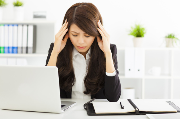 stressed  businesswoman sitting in office - Foto, Imagen