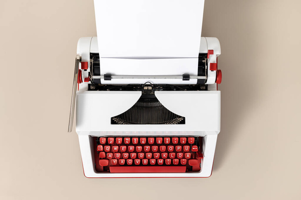 Top view of a retro and colorful typewriter with blank white paper. Creative writing process concept - Foto, imagen