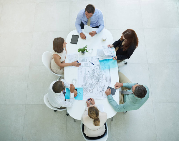 Making their ideas a reality. High angle shot of a group of businesspeople meeting in the office - Photo, Image