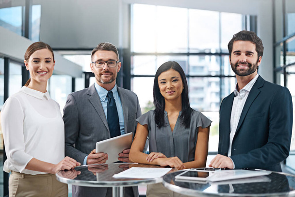 Confident in their ability to succeed. Cropped portrait of a group of businesspeople standing in the office - Foto, immagini