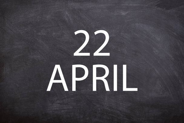 22 April text with blackboard background for calendar. And april is the fourth month of the year - Foto, afbeelding
