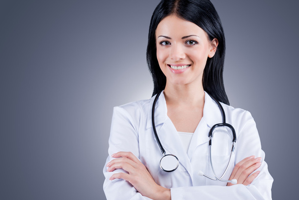 Confident female doctor in white uniform - Zdjęcie, obraz