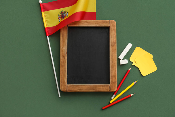 Chalkboard with stationery and flag of Spain on green background - Zdjęcie, obraz
