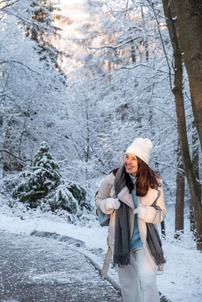 Kış parkında yürüyen gülümseyen kadın fotokopi alanı - Fotoğraf, Görsel