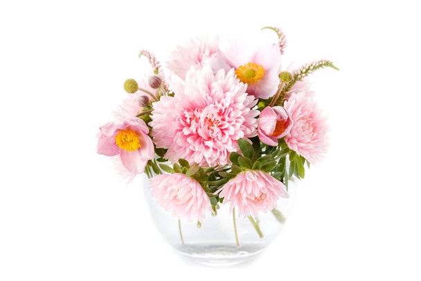 Graceful autumn bouquet of pink aster flowers, anemones in a round glass vase isolated on a white background - Photo, image