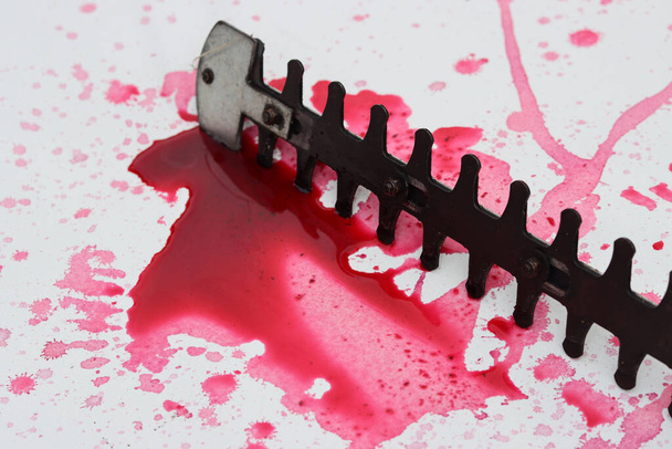 Reciprocating Saw and blood splatter on white background with copy space. Crime scene investigation concept.  - Foto, imagen
