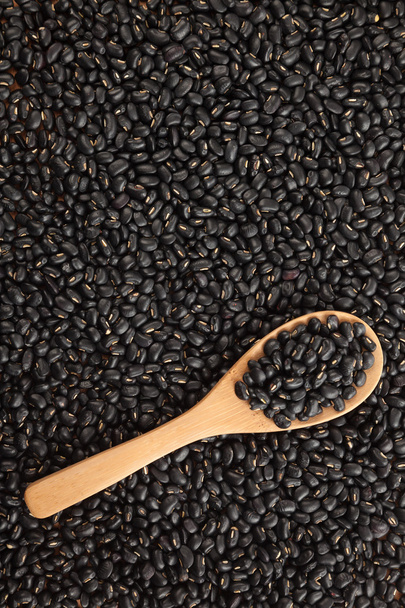 Black beans with wooden spoon - Foto, imagen