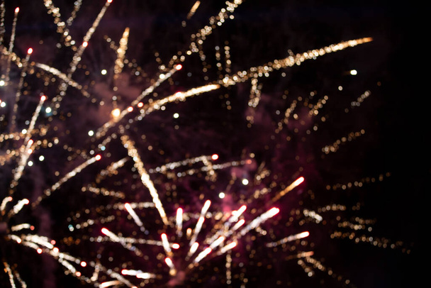 On a black background bokeh from explosions of colorful fireworks. - Foto, Bild