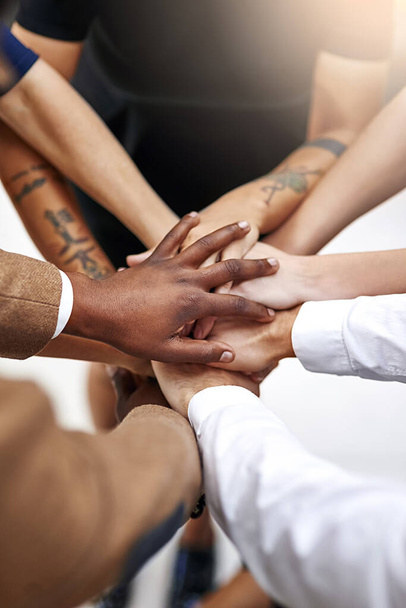 Teamwork and success go hand in hand. Closeup shot of a group of people joining their hands together in unity - Foto, Bild
