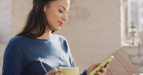 Social media, online dating profile and phone texting woman drinking coffee, smile and thinking of message, typing and break at home. Happy person, mobile technology web app and internet notification. - Video