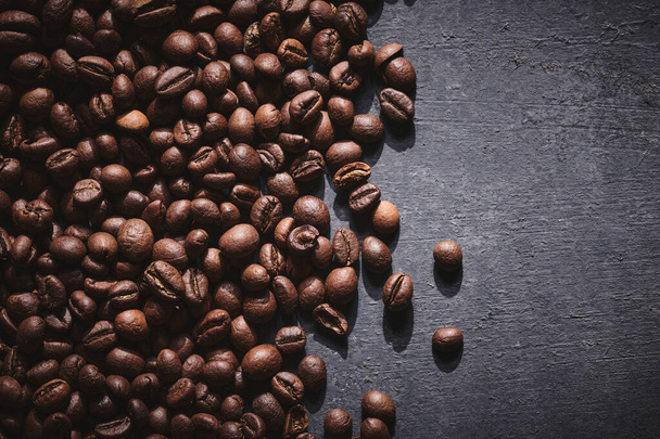 Roasted coffee beans on gray background - Foto, Imagen