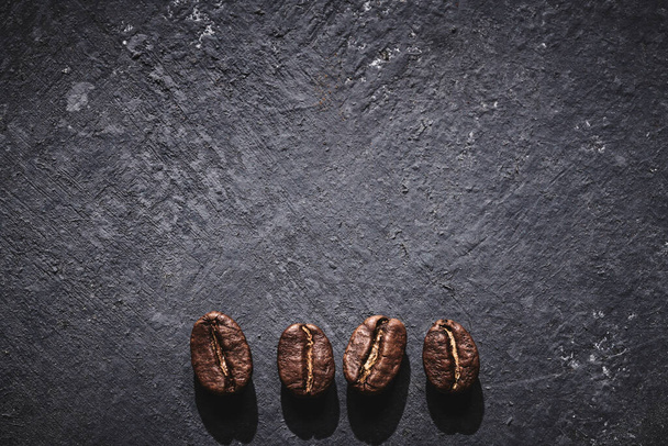 Roasted coffee beans on gray background - Photo, Image