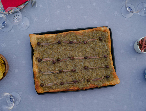 Pissaladiere on a table in summer - Fotó, kép