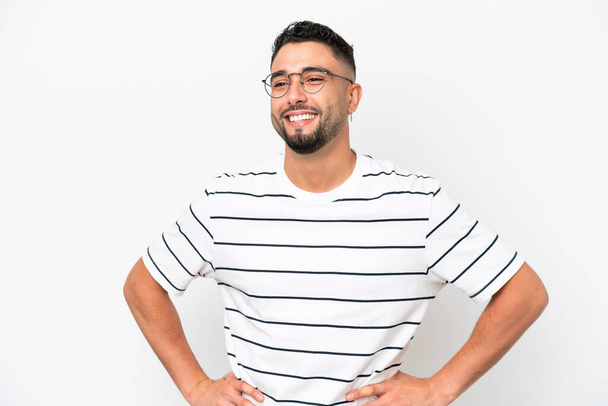 Young Arab handsome man isolated on white background posing with arms at hip and smiling - Φωτογραφία, εικόνα