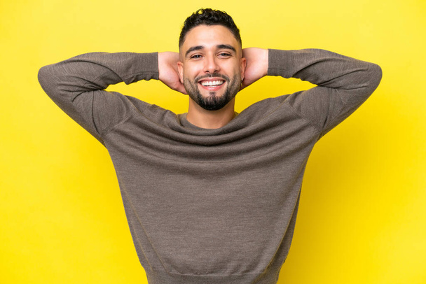 Young Arab handsome man isolated on yellow background laughing - Фото, изображение