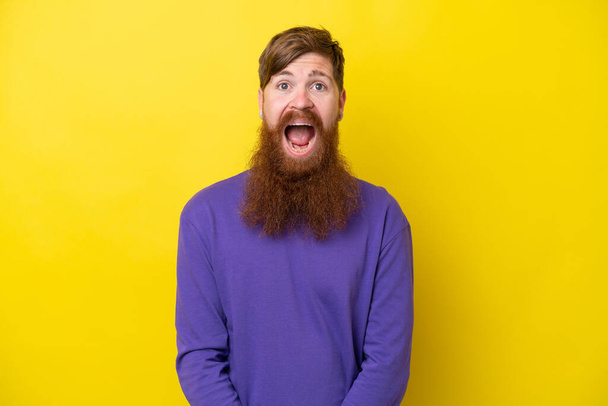 Redhead man with beard isolated on yellow background with surprise facial expression - Photo, Image