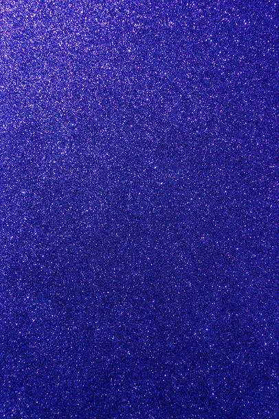 Background with sparkles. Backdrop with glitter. Shiny textured surface. Vertical image. Very dark blue. Soft light - Valokuva, kuva