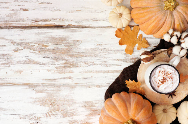 Cozy fall double side with pumpkins, leaves, sweater and pumpkin spice latte. Top down view over a rustic white wood background. - Fotó, kép