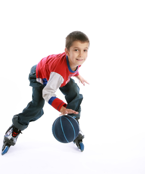 Boy playing ball on the roller-skates - Фото, изображение