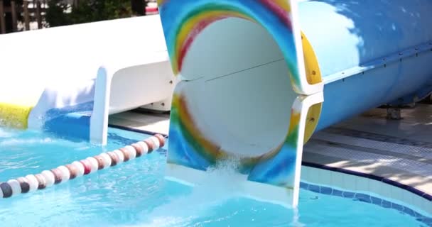 Person flies out of water pipe in water park. Fun and slides in the water park concept - Video